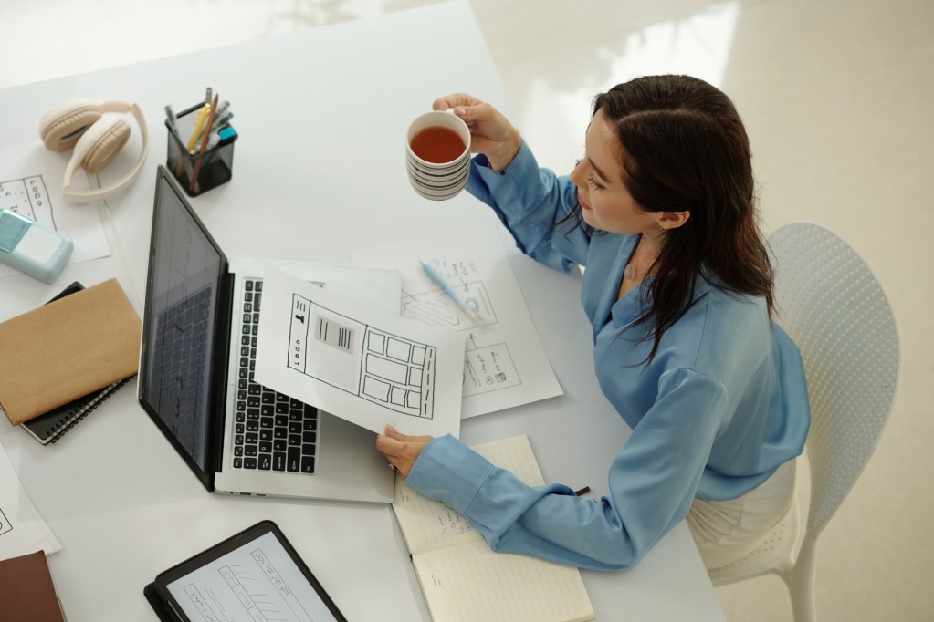 Businesswoman Reviewing Digital Documents with Coffee